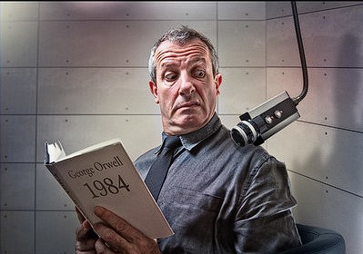 A picture of George Orwell reading his book '1984'